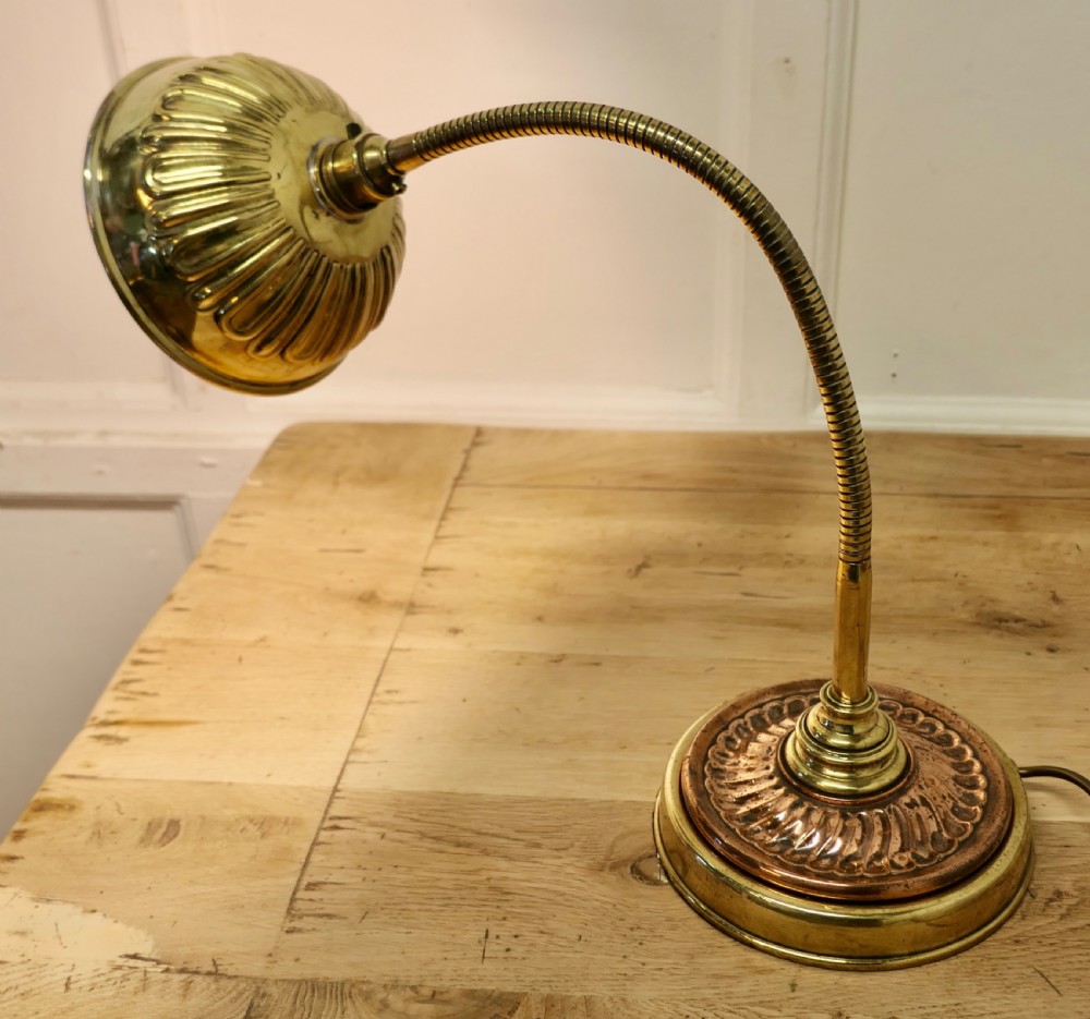 An Art Deco desk lamp featuring a flexible gooseneck arm, a ribbed brass shade, and a circular copper and brass base. View II