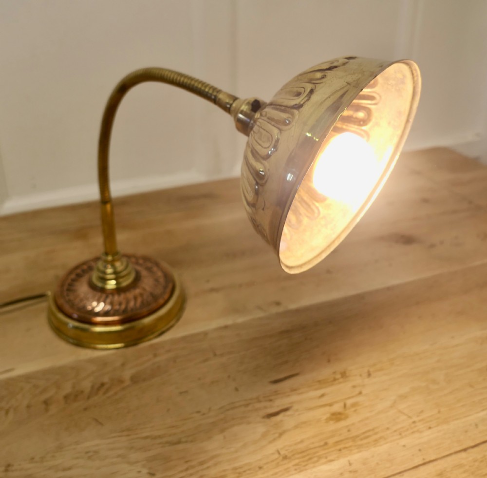An Art Deco desk lamp featuring a flexible gooseneck arm, a ribbed brass shade, and a circular copper and brass base. View III