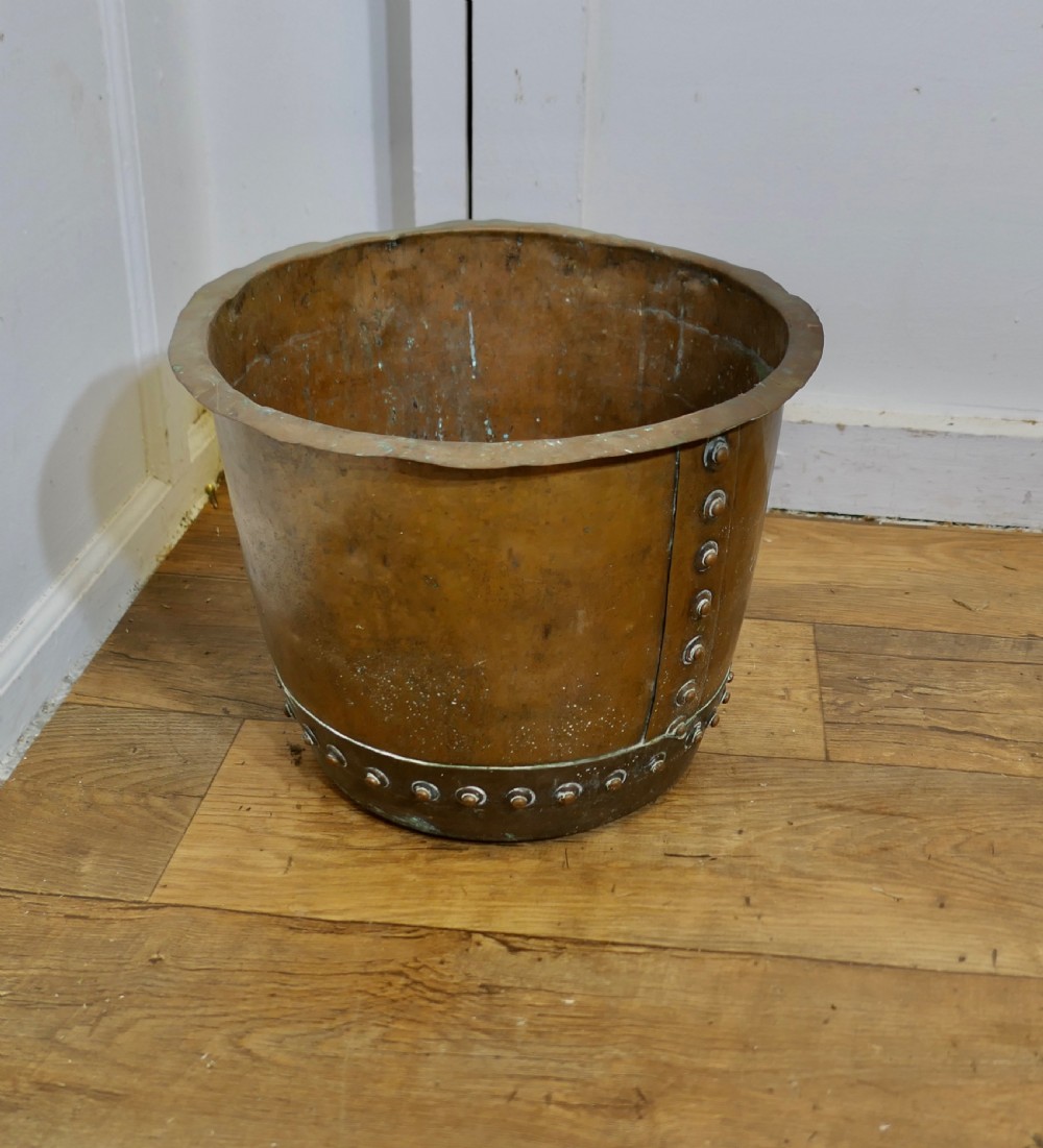 A cylindrical early nineteenth-century hand-hammered copper tub featuring a flared upper lip and a base reinforced with a riveted metal band. View IV