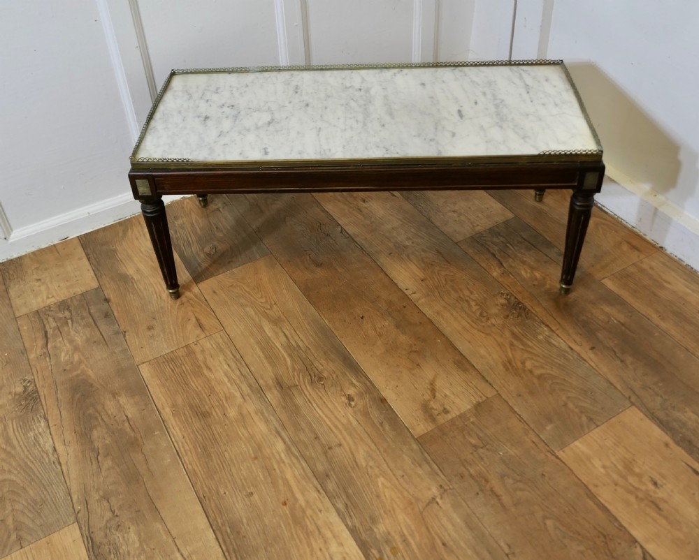 A French nineteenth-century rectangular dark wood low table with fluted tapered legs, brass feet, and a pierced brass gallery around the top edge. View II