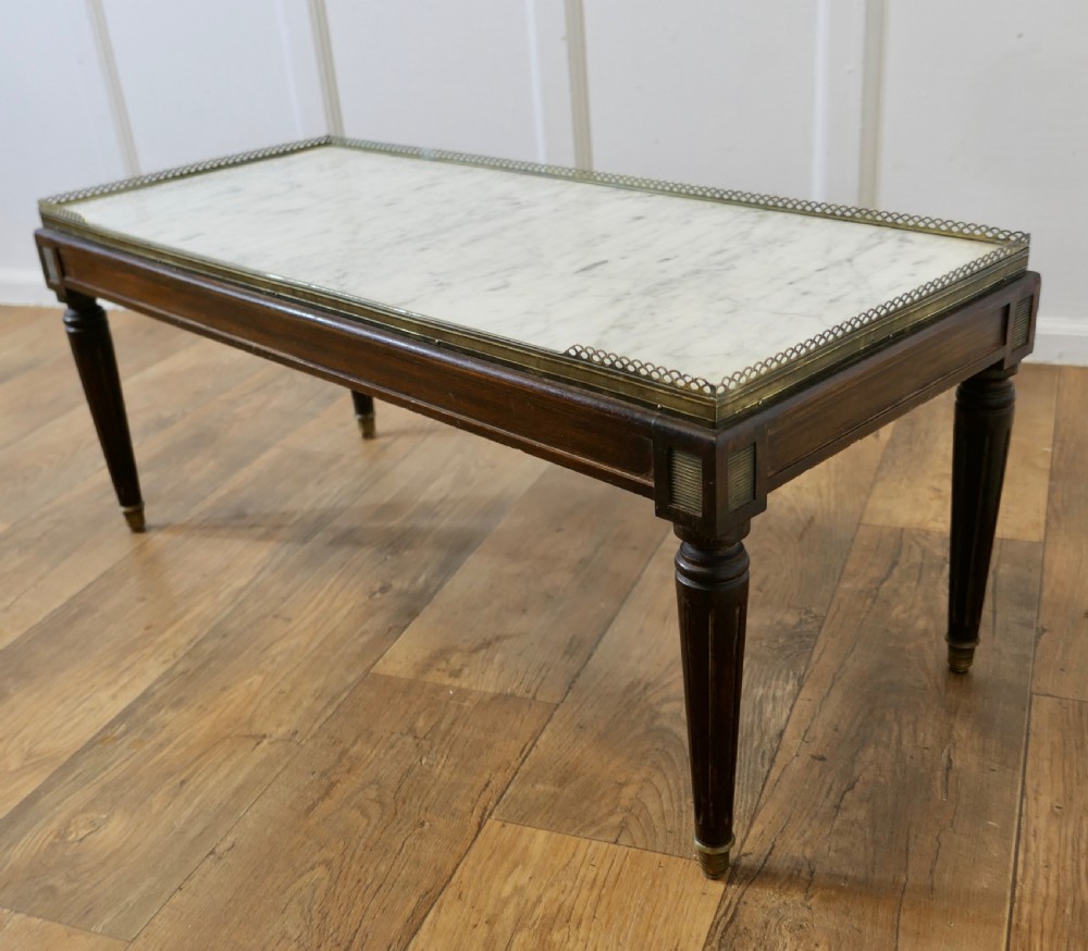 A French nineteenth-century rectangular dark wood low table with fluted tapered legs, brass feet, and a pierced brass gallery around the top edge. View VII