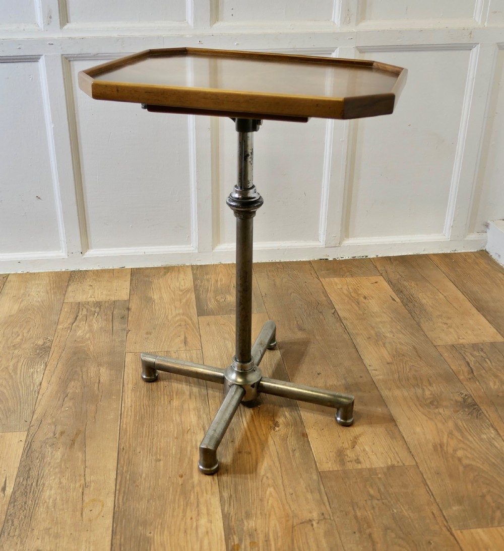 An Art Deco adjustable reading stand featuring two walnut wooden tray tops on a tubular chrome column and cross-form base. View VIII