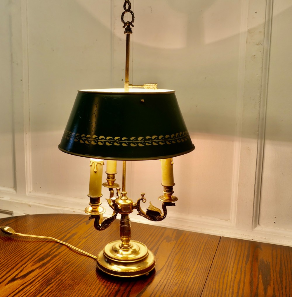 A French toleware and brass bouillotte desk lamp featuring three candle-style lights under a dark green painted metal shade with gilt leaf decoration. View II