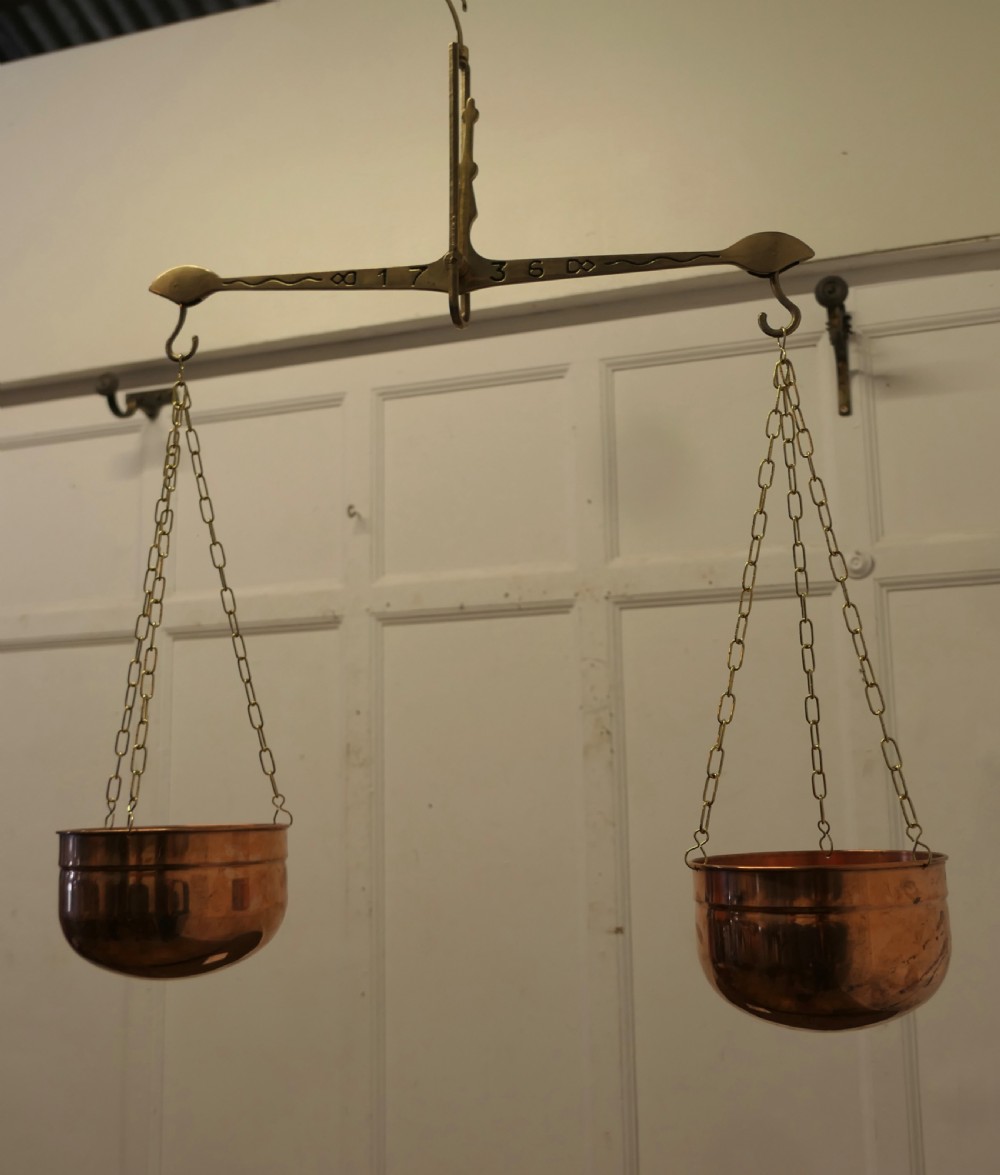 A pair of polished copper pans suspended by brass chains from an engraved brass balance beam. View IV