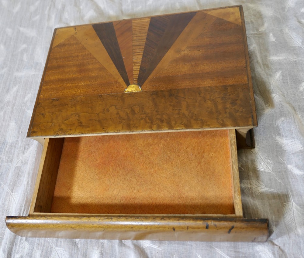An Art Deco book-shaped wooden secret safe featuring a geometric sunburst parquetry design crafted from contrasting timber veneers. View V