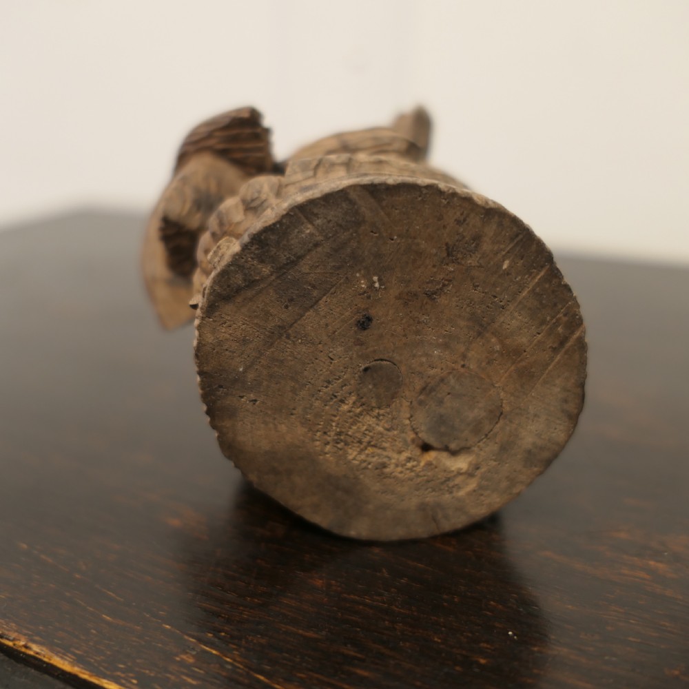 A hand-carved wooden head of a Scottish terrier with glass eyes and carved fur details. View VIII