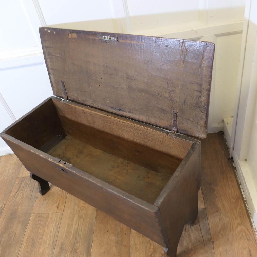 A dark oak plank coffer featuring a geometric carved pattern on the top lid, slab ends, and a central keyhole. View V