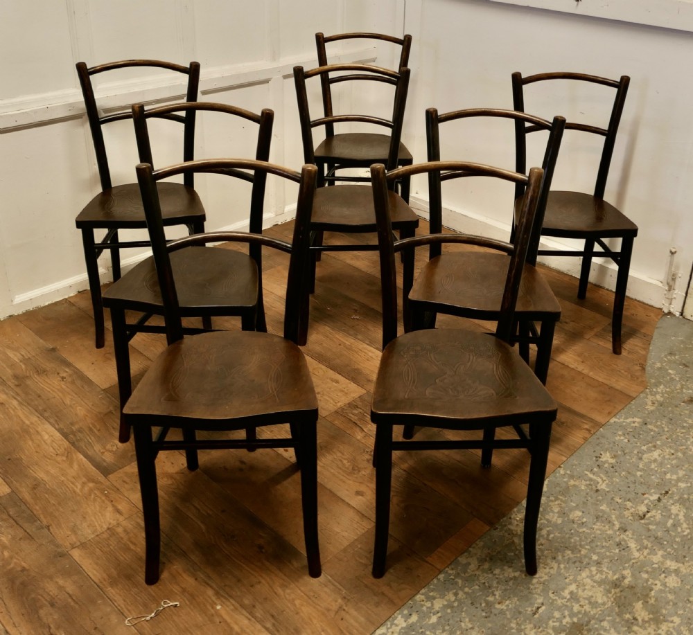 Set of eight dark brown 19th-century Thonet bentwood bistro chairs with steam-bent frames and embossed wooden seats.