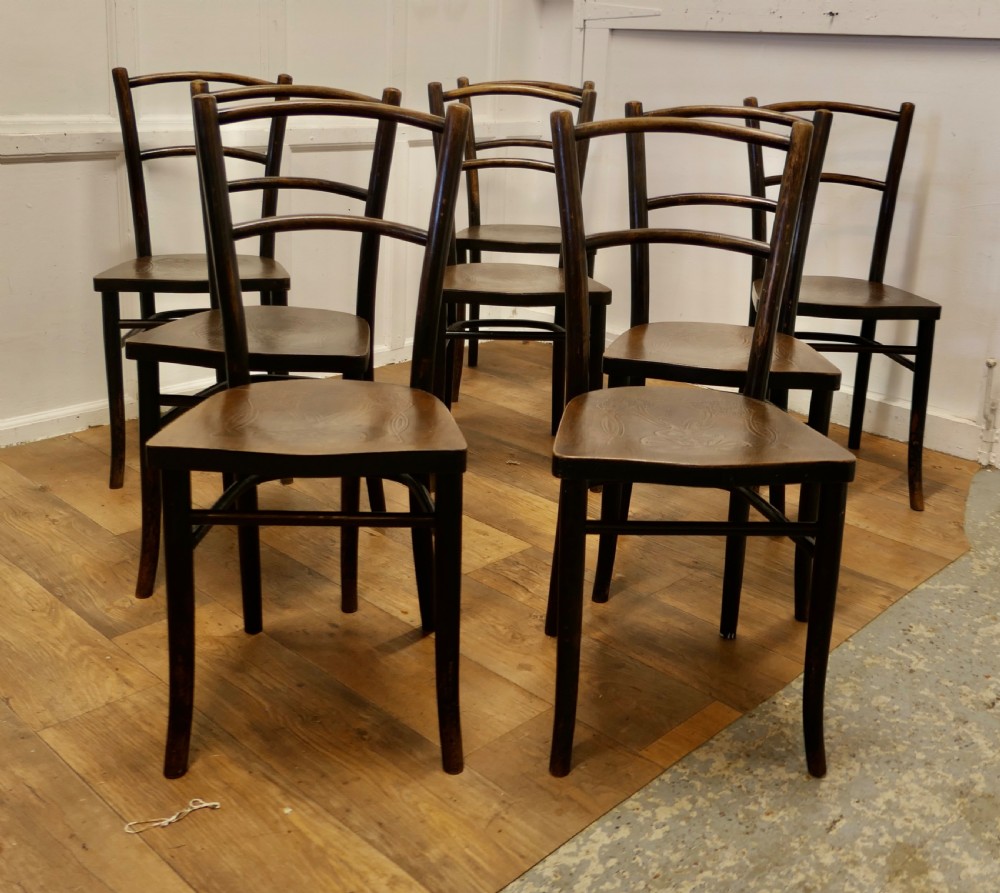 Set of eight dark brown 19th-century Thonet bentwood bistro chairs with steam-bent frames and embossed wooden seats. View II