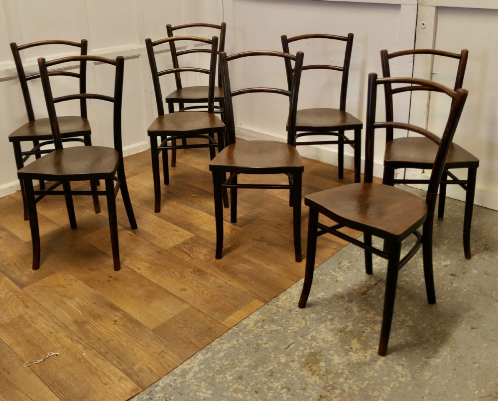 Set of eight dark brown 19th-century Thonet bentwood bistro chairs with steam-bent frames and embossed wooden seats. View III