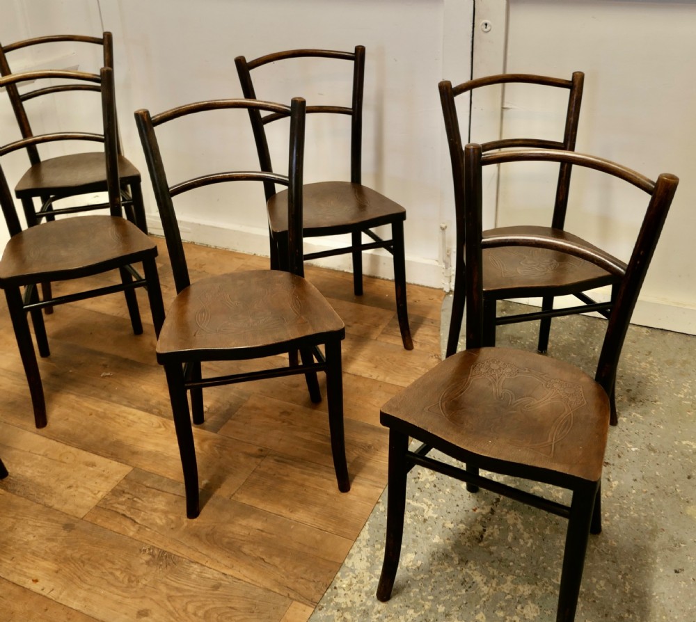 Set of eight dark brown 19th-century Thonet bentwood bistro chairs with steam-bent frames and embossed wooden seats. View V
