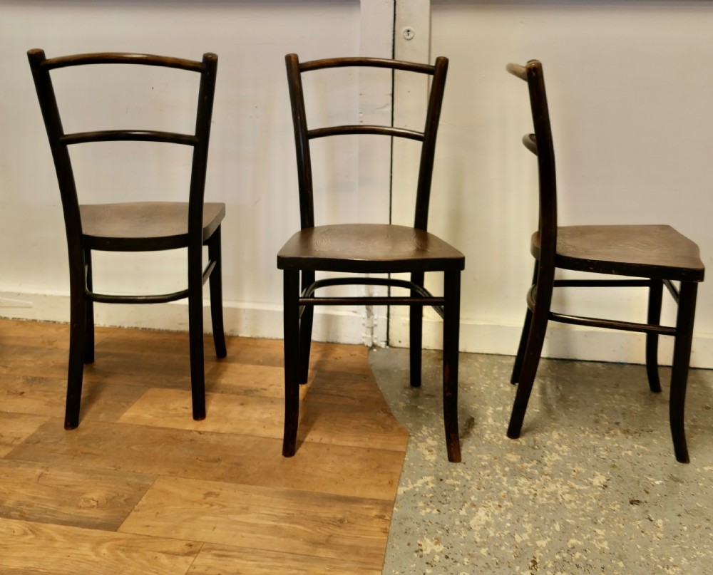 Set of eight dark brown 19th-century Thonet bentwood bistro chairs with steam-bent frames and embossed wooden seats. View VI