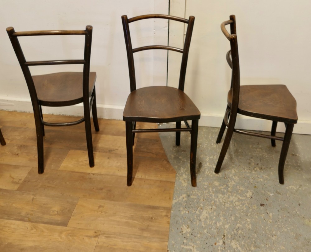 Set of eight dark brown 19th-century Thonet bentwood bistro chairs with steam-bent frames and embossed wooden seats. View VIII