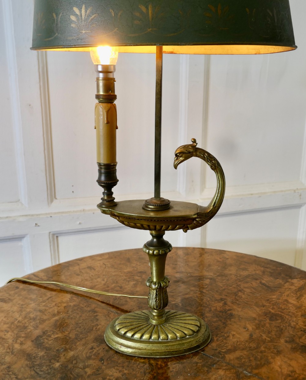 A French Neoclassical desk lamp featuring a dark green painted metal shade with gold stencilling mounted on a cast brass base with a swan-head neck motif. View VI