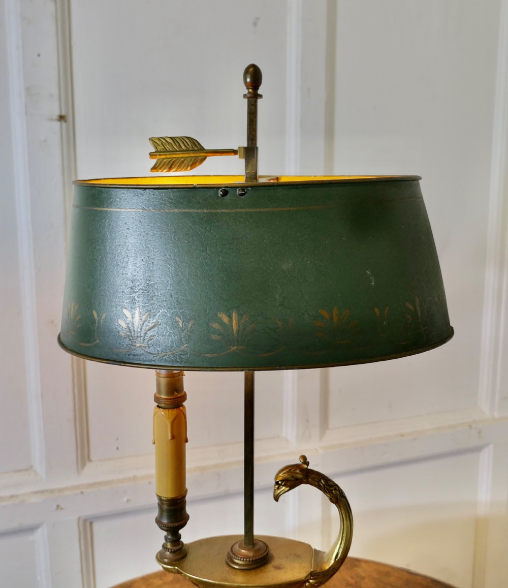 A French Neoclassical desk lamp featuring a dark green painted metal shade with gold stencilling mounted on a cast brass base with a swan-head neck motif. View VIII