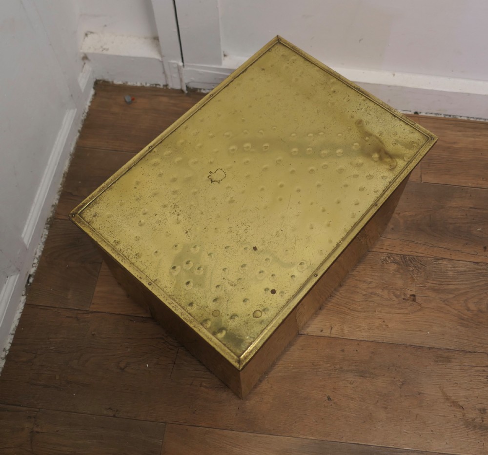 A rectangular Art Deco brass fireside log box featuring a hammered embossed surface texture and a flat hinged lid. View IV