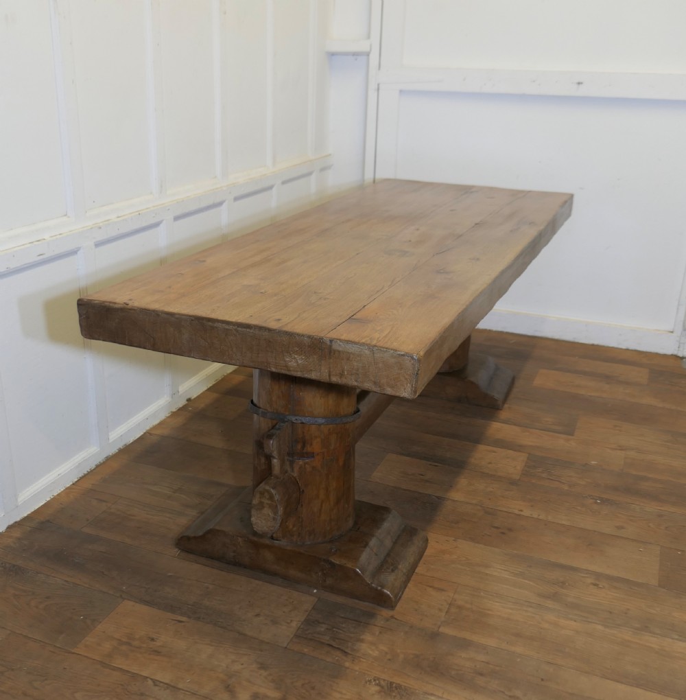 A 19th-century French oak refectory table featuring a thick rectangular top supported by heavy cylindrical pedestal legs connected by a central stretcher. View III