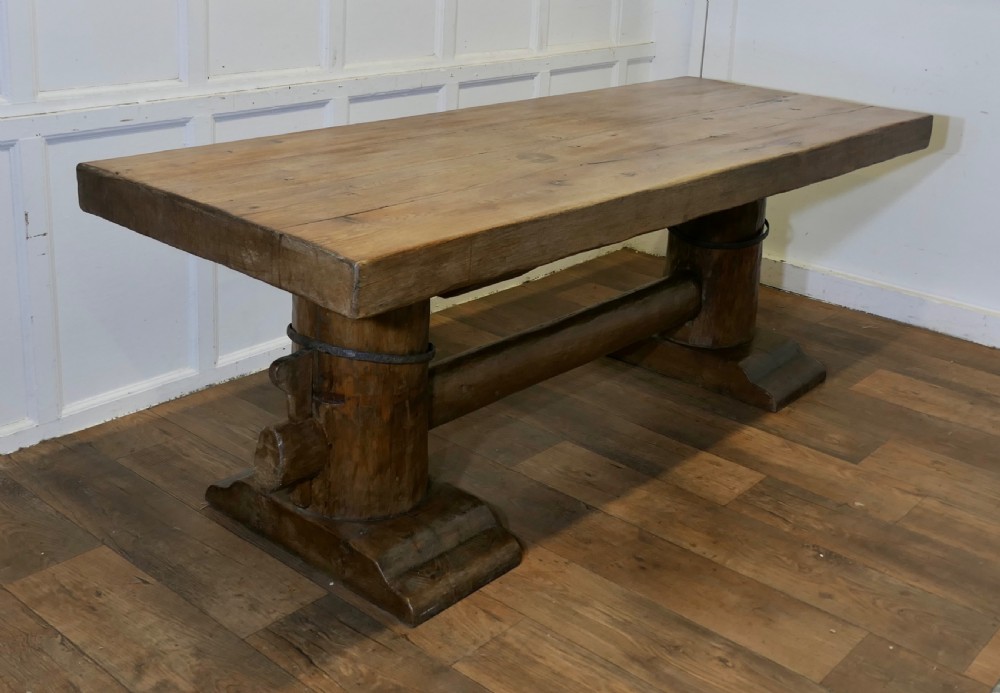 A 19th-century French oak refectory table featuring a thick rectangular top supported by heavy cylindrical pedestal legs connected by a central stretcher. View VII