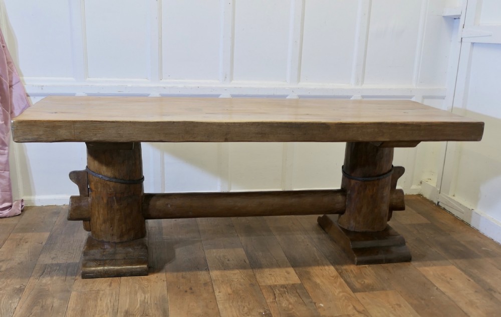 A 19th-century French oak refectory table featuring a thick rectangular top supported by heavy cylindrical pedestal legs connected by a central stretcher. View VIII