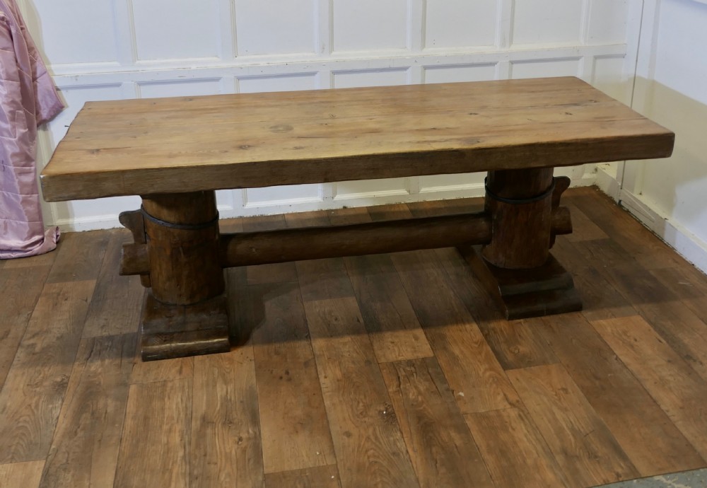 A 19th-century French oak refectory table featuring a thick rectangular top supported by heavy cylindrical pedestal legs connected by a central stretcher. View IX