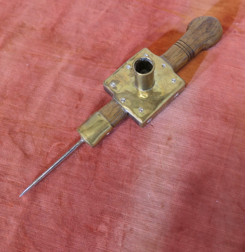 An antique French winery beam spike made from turned oak wood with a square brass socket plate and a long iron spike. View IV