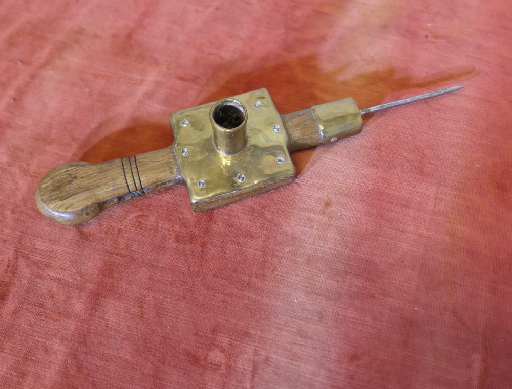 An antique French winery beam spike made from turned oak wood with a square brass socket plate and a long iron spike. View V