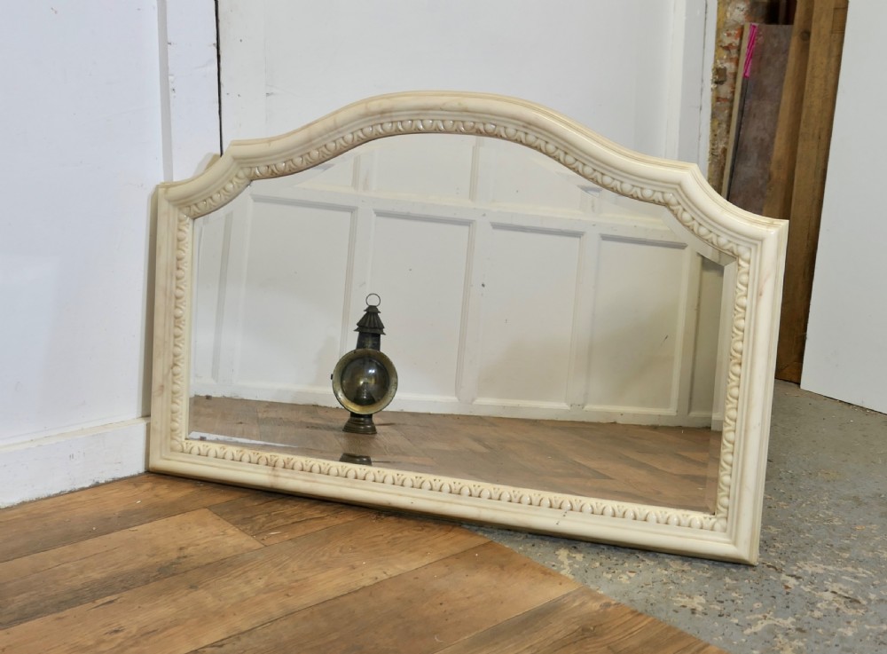 A large arched overmantel mirror featuring a cream simulated marble finish and carved egg-and-dart moulding along the interior rim. View III