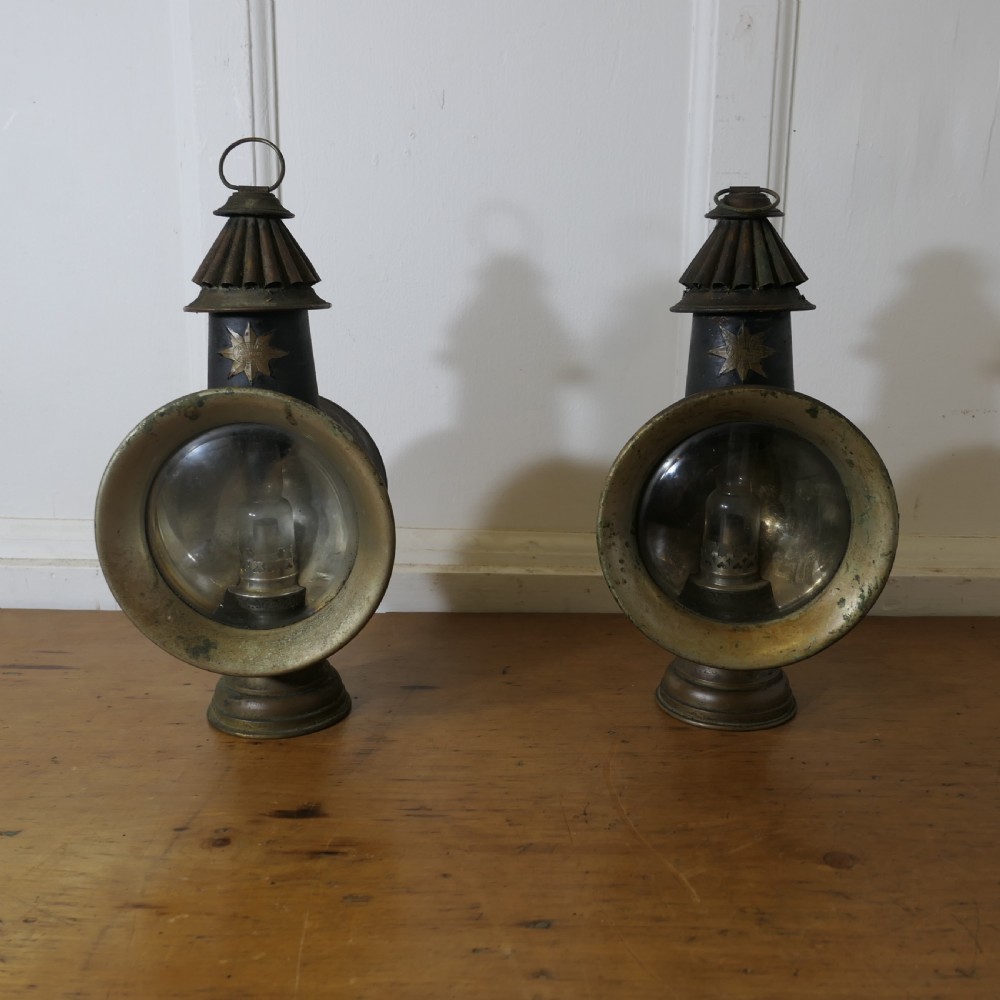 A pair of 19th-century French brass and iron carriage lamps with fluted chimney tops, brass star emblems, and circular convex glass lenses. View II