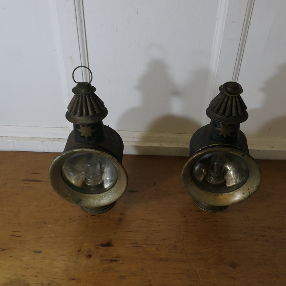 A pair of 19th-century French brass and iron carriage lamps with fluted chimney tops, brass star emblems, and circular convex glass lenses. View III