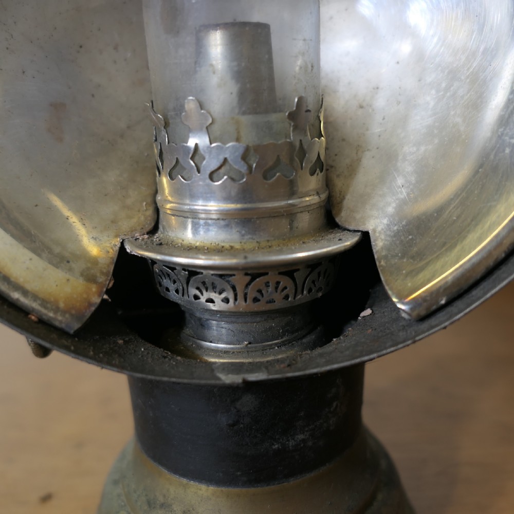 A pair of 19th-century French brass and iron carriage lamps with fluted chimney tops, brass star emblems, and circular convex glass lenses. View IX