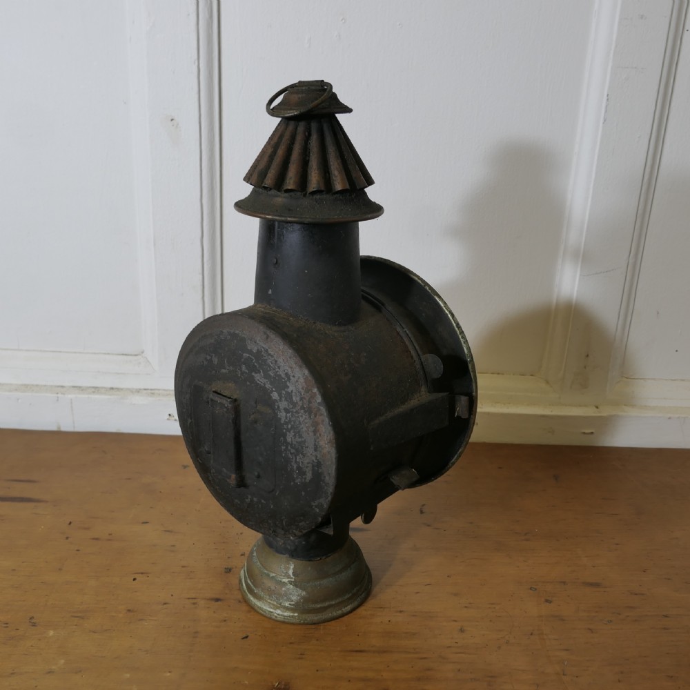 A pair of 19th-century French brass and iron carriage lamps with fluted chimney tops, brass star emblems, and circular convex glass lenses. View X