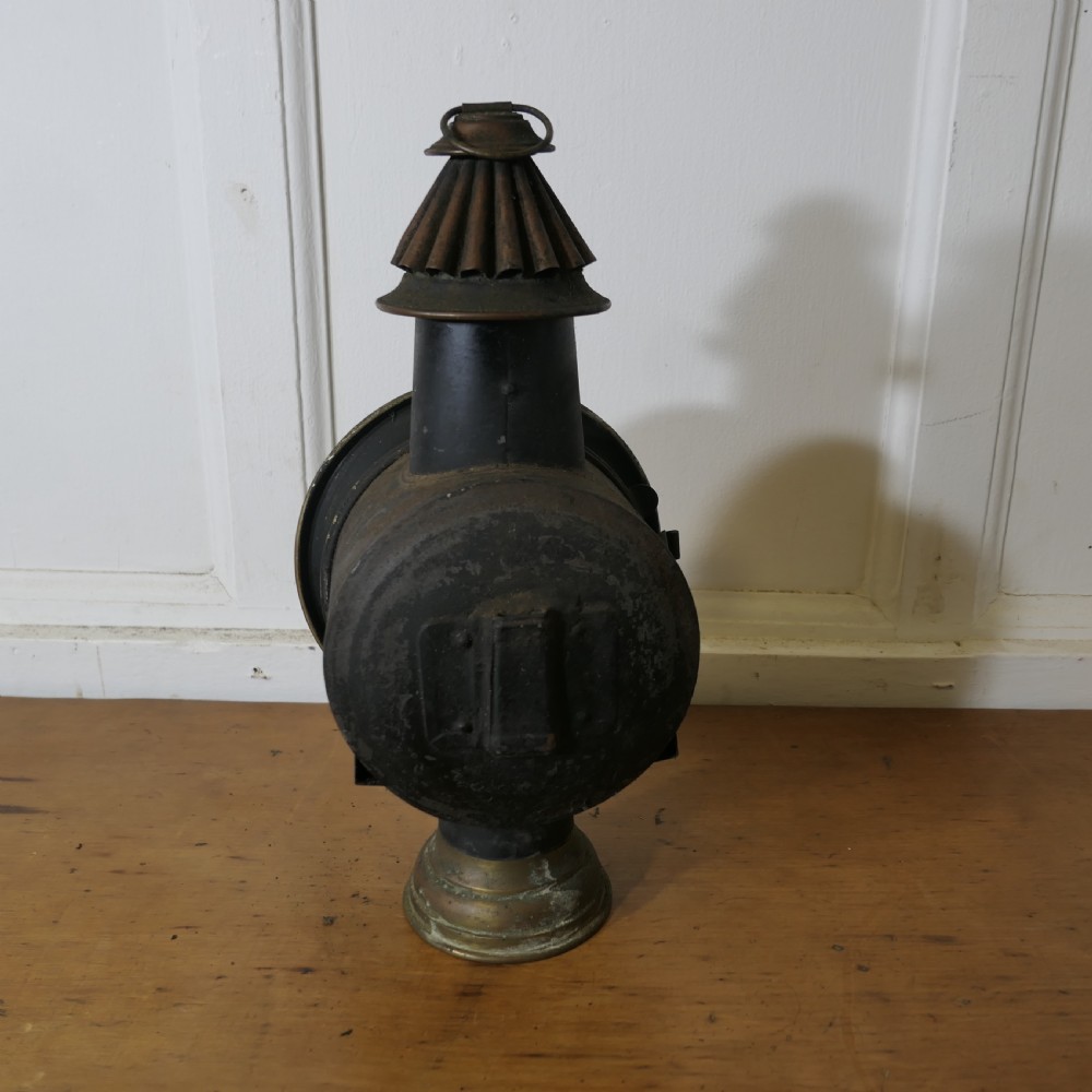 A pair of 19th-century French brass and iron carriage lamps with fluted chimney tops, brass star emblems, and circular convex glass lenses. View XI