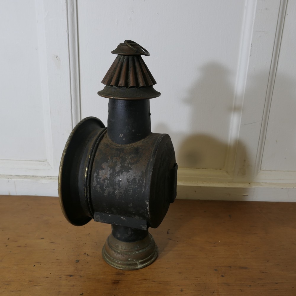 A pair of 19th-century French brass and iron carriage lamps with fluted chimney tops, brass star emblems, and circular convex glass lenses. View XII