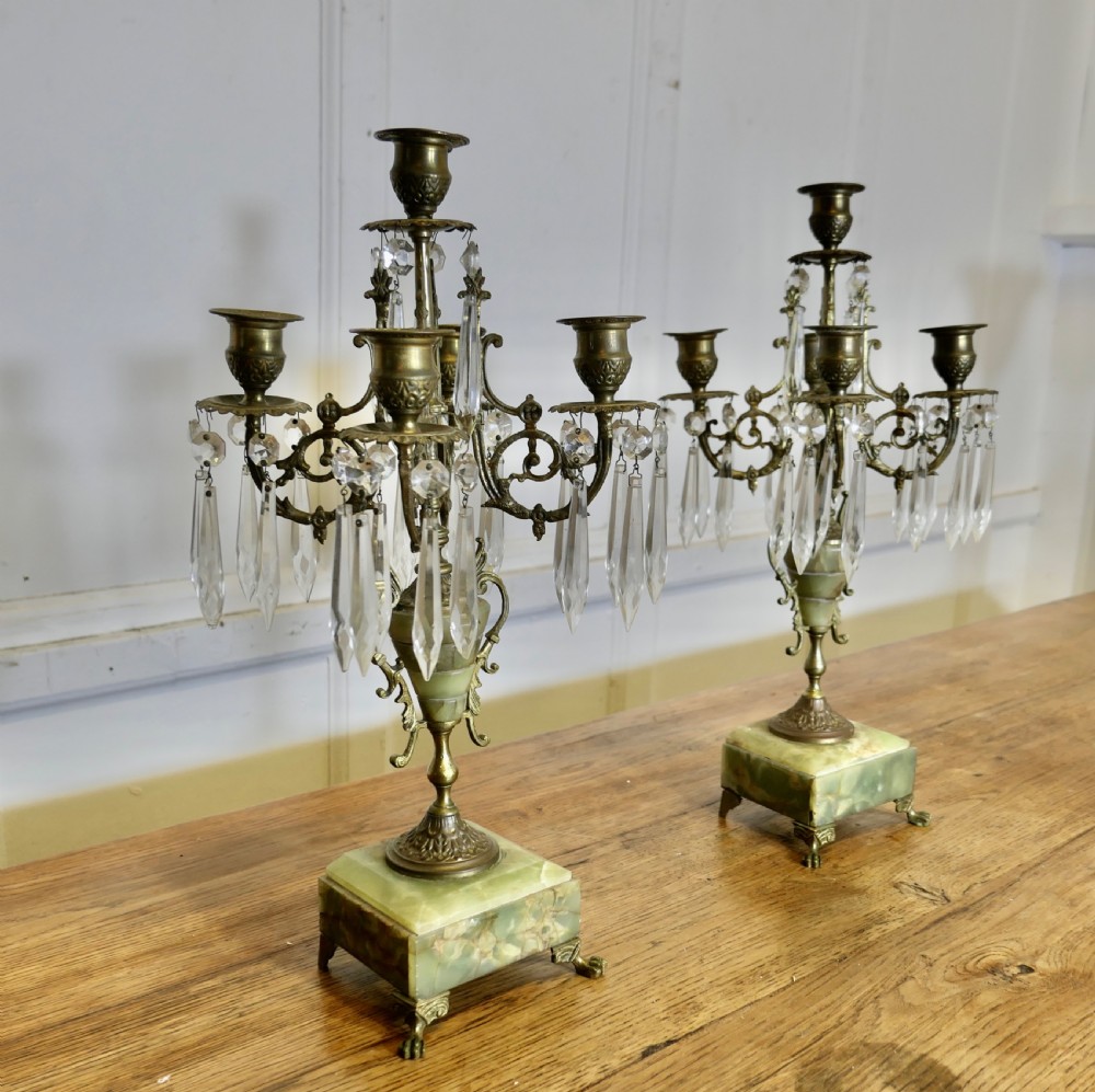 A pair of cast brass five-branch candelabra featuring green onyx stone urns, plinths, and clear crystal glass prisms. View VI