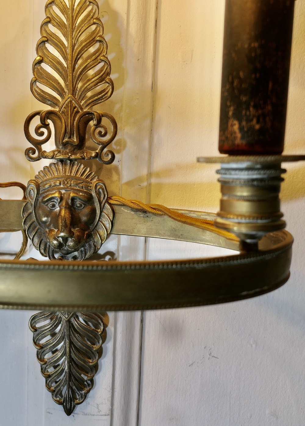 A French-style wall light featuring a dark green oval toleware shade and a cast brass backplate decorated with palmette leaves and a mask design. View III