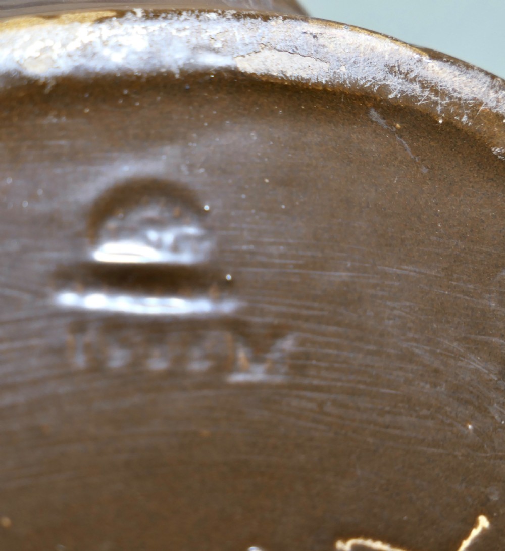 A cylindrical Bretby earthenware jardiniere featuring dark brown glazed twin handles and a cream central band decorated with relief-carved Japanese figures. View VIII