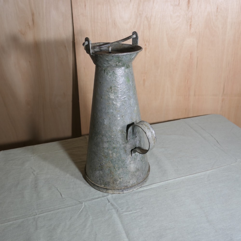 A tall conical galvanised metal water jug embossed with BR S featuring a side loop handle and a top hinged lid assembly. View III