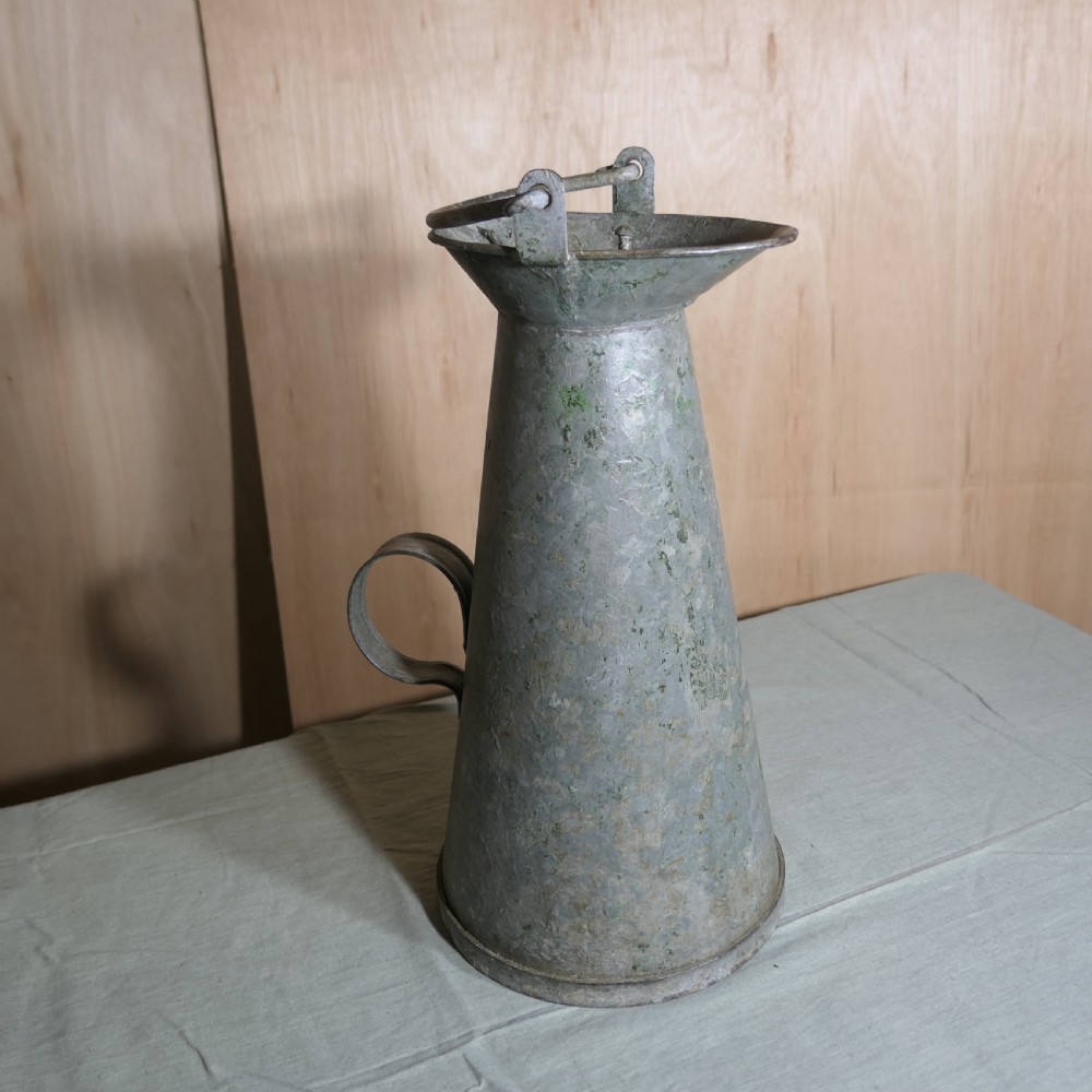 A tall conical galvanised metal water jug embossed with BR S featuring a side loop handle and a top hinged lid assembly. View V