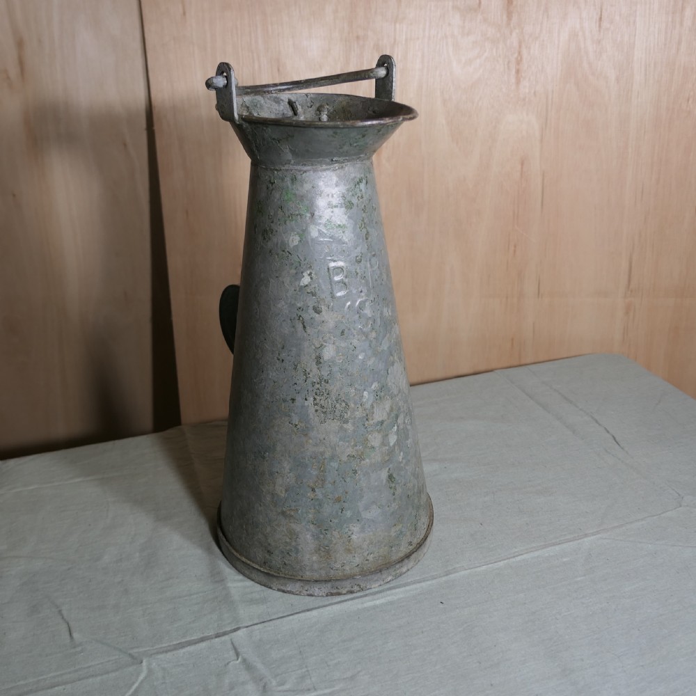 A tall conical galvanised metal water jug embossed with BR S featuring a side loop handle and a top hinged lid assembly. View VI