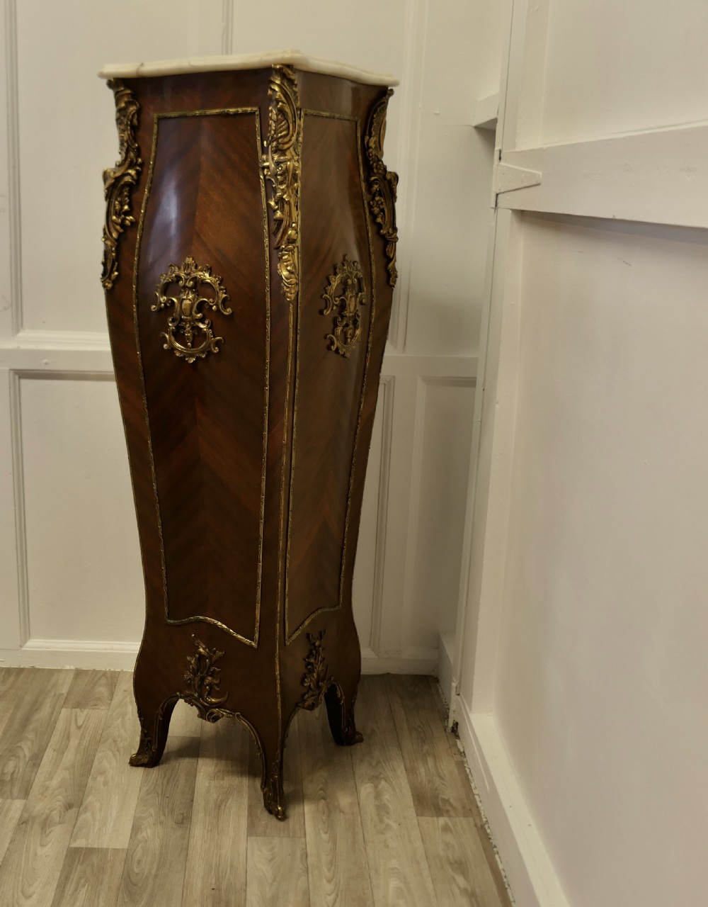 A tall French Rococo style walnut pedestal featuring a marble top, chevron wood veneer, and intricate gilt-bronze ormolu mounts. View III