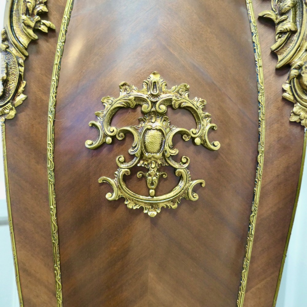 A tall French Rococo style walnut pedestal featuring a marble top, chevron wood veneer, and intricate gilt-bronze ormolu mounts. View V