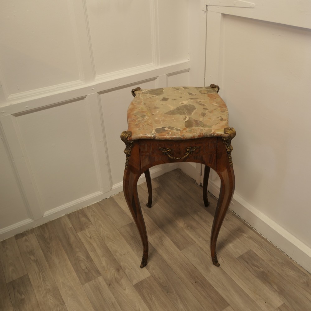 A French Louis XV style side table featuring a marble top, slender cabriole legs, parquetry wood inlay, and decorative ormolu mounts. View II