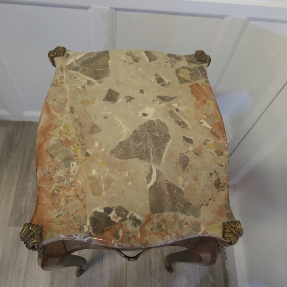 A French Louis XV style side table featuring a marble top, slender cabriole legs, parquetry wood inlay, and decorative ormolu mounts. View V