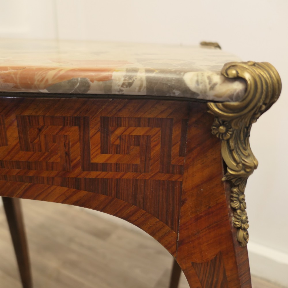 A French Louis XV style side table featuring a marble top, slender cabriole legs, parquetry wood inlay, and decorative ormolu mounts. View VI
