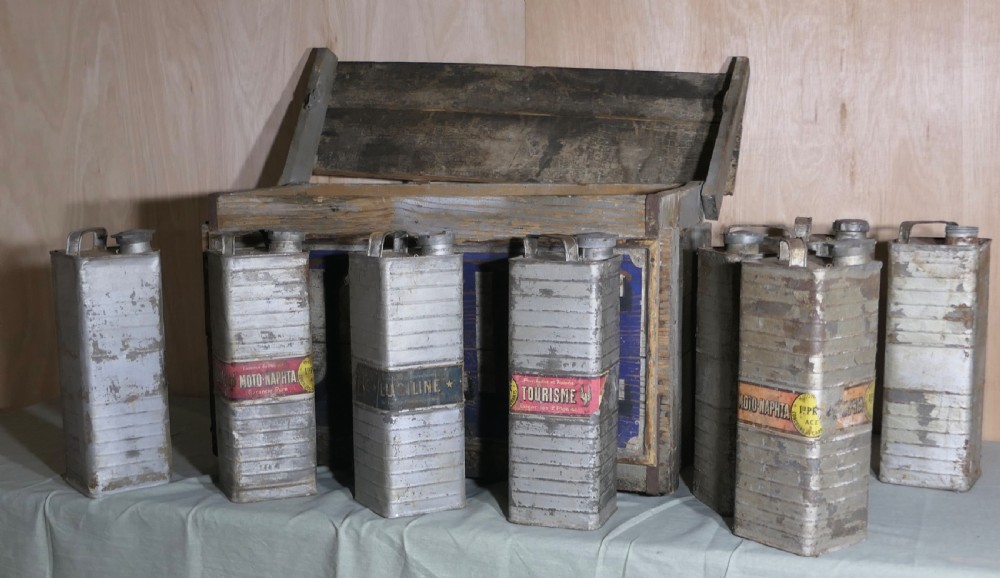 A rectangular weathered wooden shipping crate featuring painted blue typography spelling Luciline across the front panel with metal edge reinforcements. View V