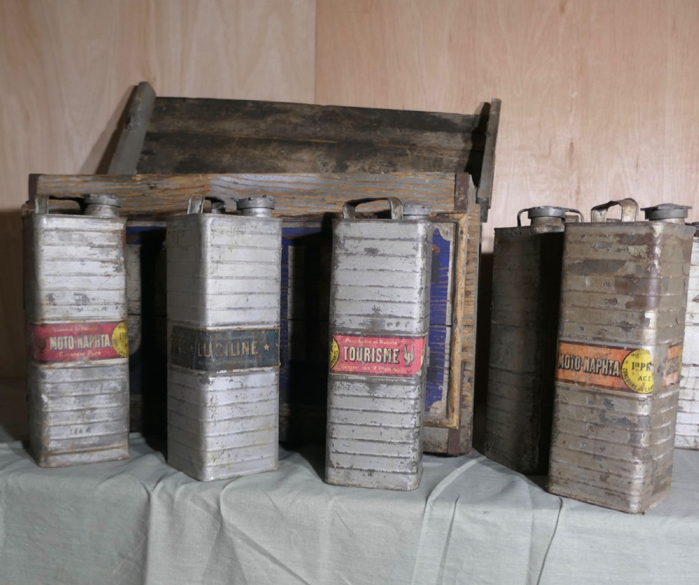A rectangular weathered wooden shipping crate featuring painted blue typography spelling Luciline across the front panel with metal edge reinforcements. View VI