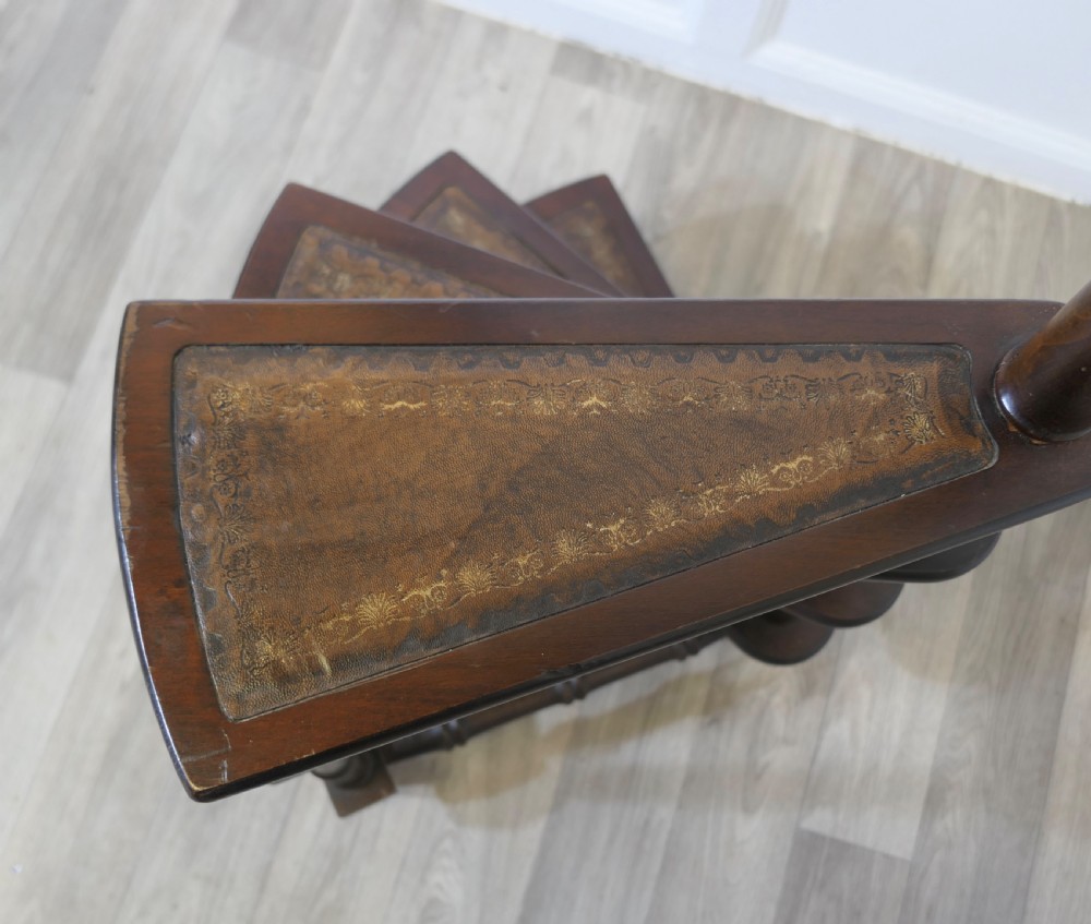 Antique dark wood spiral library steps with four leather-inset treads, turned spindle supports, and a tall central pole capped with a brass finial. View VI