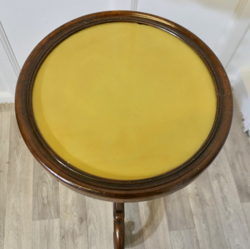 A Victorian dark wood circular wine table featuring a barley twist column and a scrolled tripod base. View V