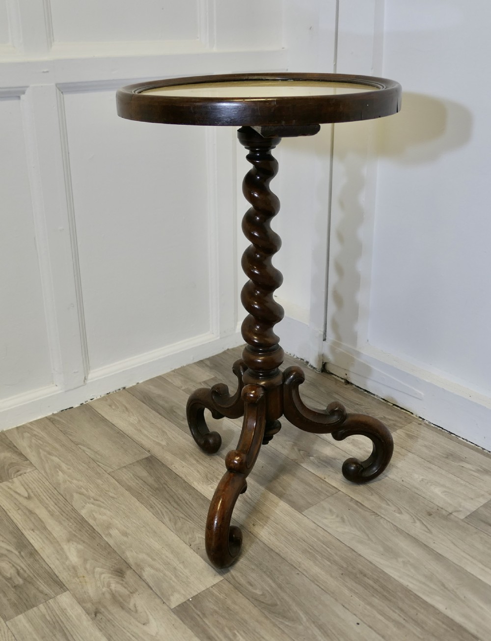 A Victorian dark wood circular wine table featuring a barley twist column and a scrolled tripod base. View VII