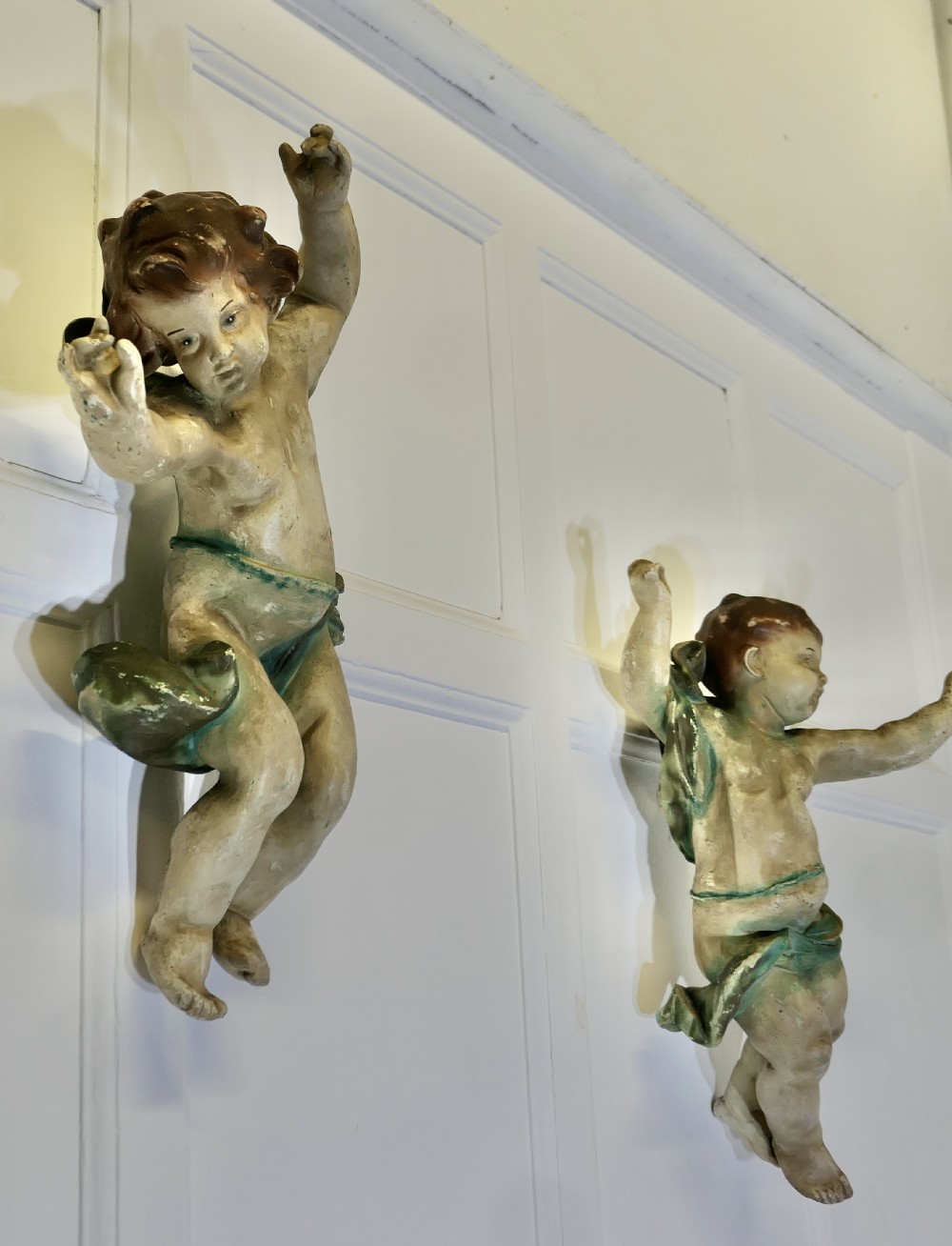 A pair of 19th-century Italian carved wood putti featuring painted dynamic poses and green drapery. View XI